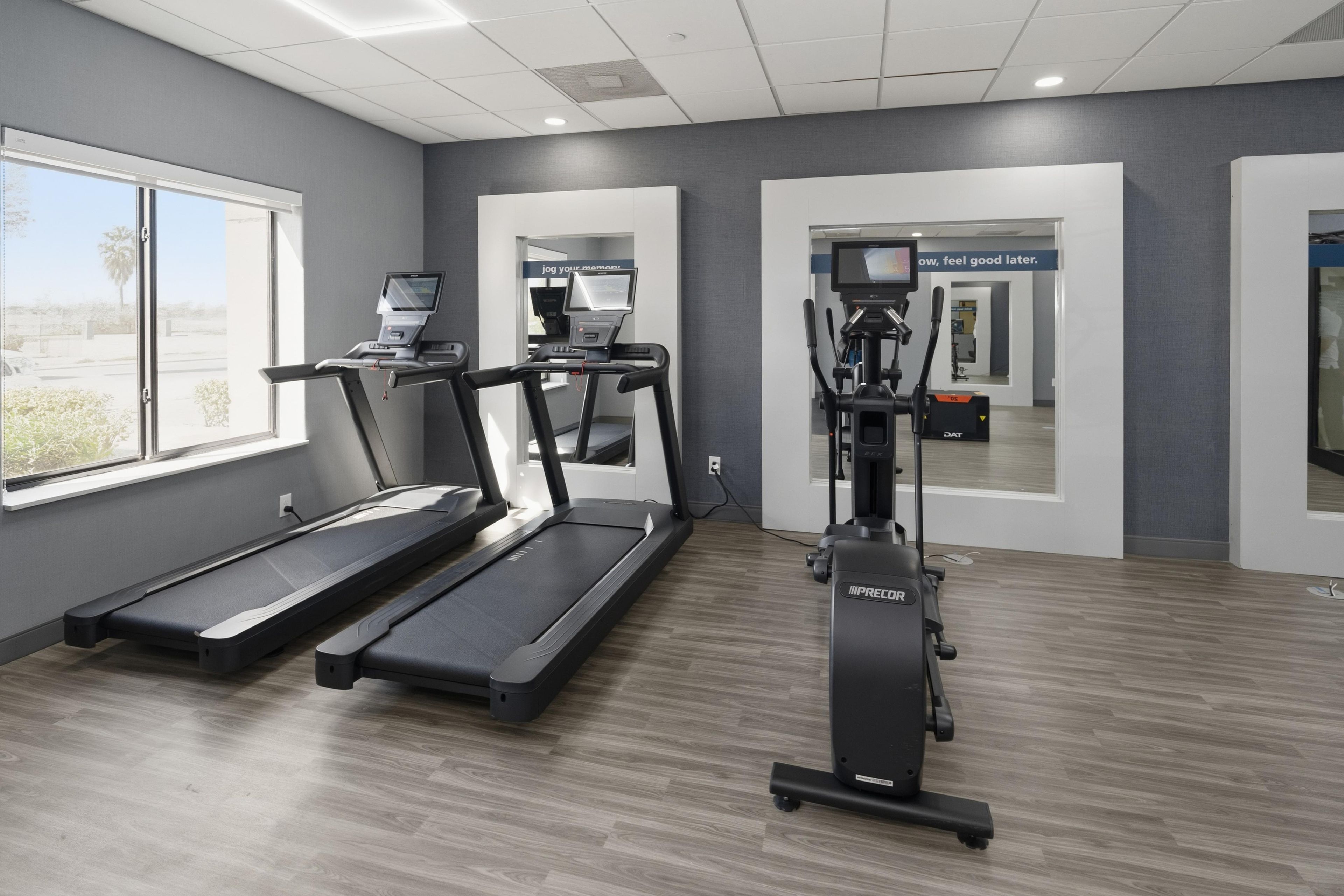 A gym with treadmills, a stationary bike, and a weight machine.