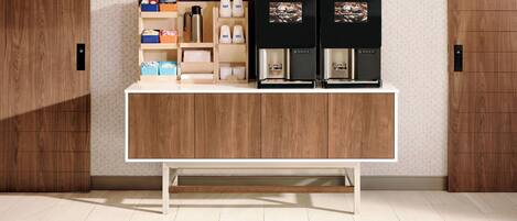 A wooden counter with storage shelves, a coffee machine, and a coffee dispenser.