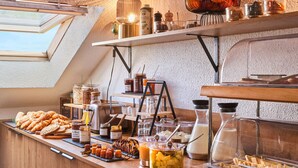 A breakfast buffet with various food items and condiments.