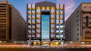 A multi-story hotel with a prominent entrance and illuminated signage.