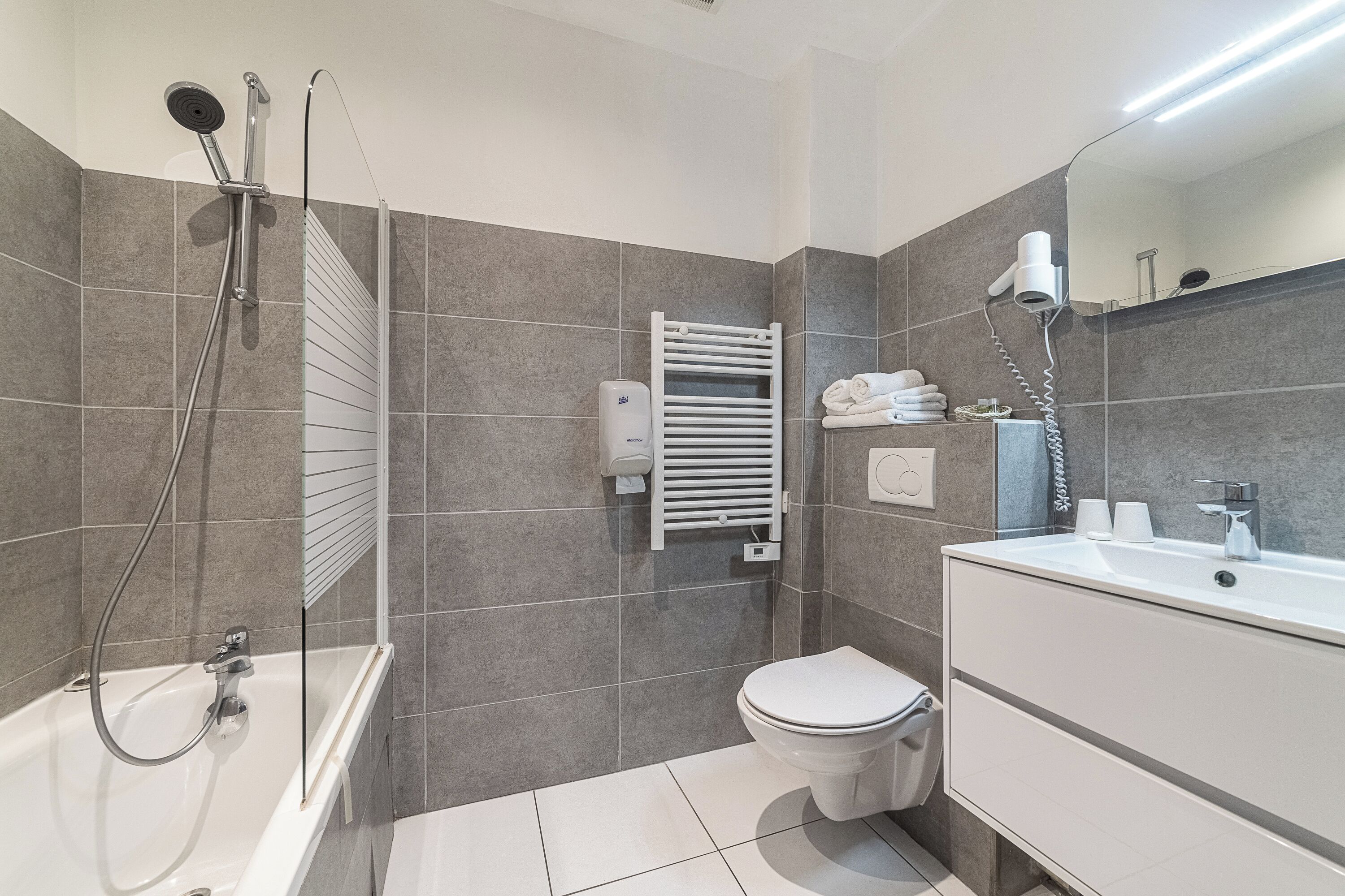 standard double room - village view | bathroom | shower, hair dryer, towels
