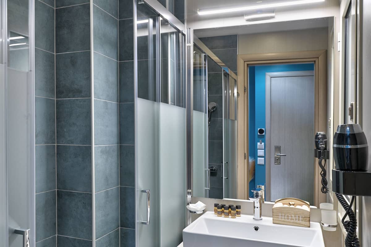 quadruple room | bathroom | rainfall showerhead, free toiletries, hair dryer, slippers