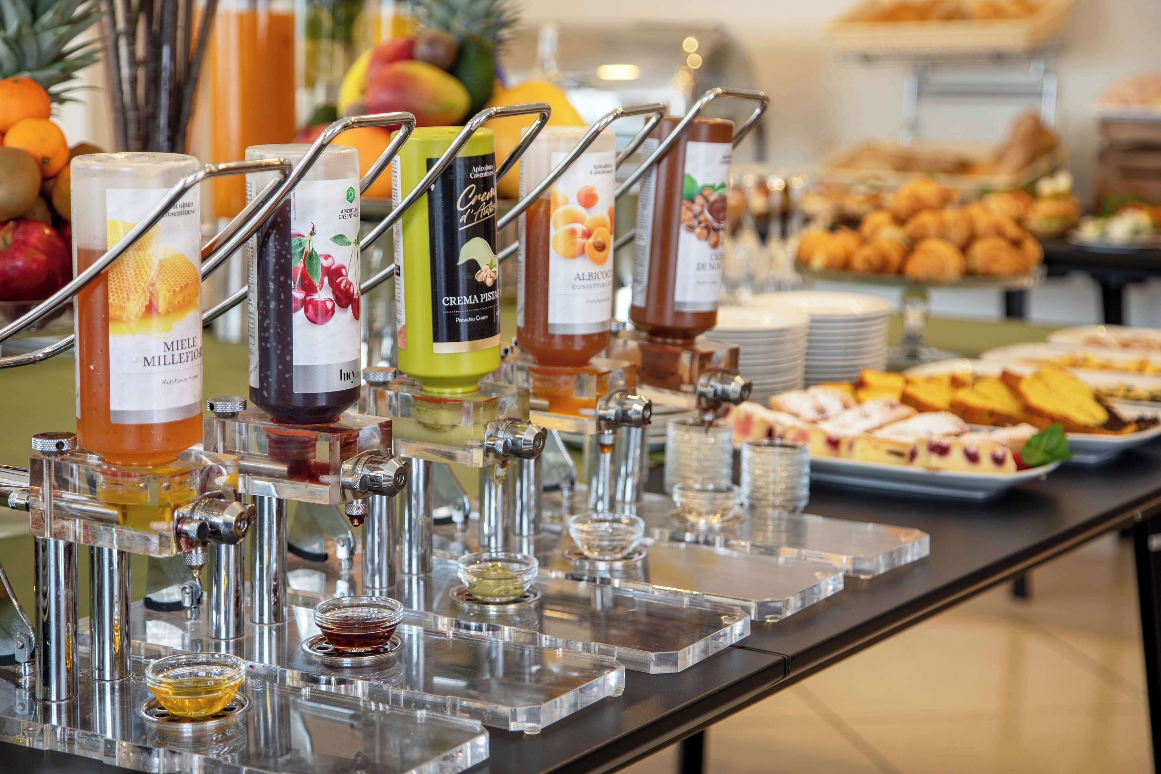 A buffet with various food items and beverage dispensers.