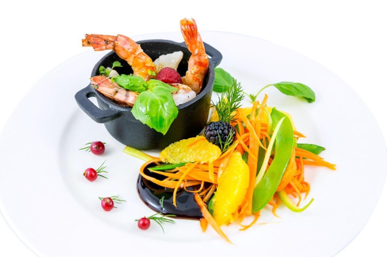 A dish with shrimp, vegetables, and a black bowl.
