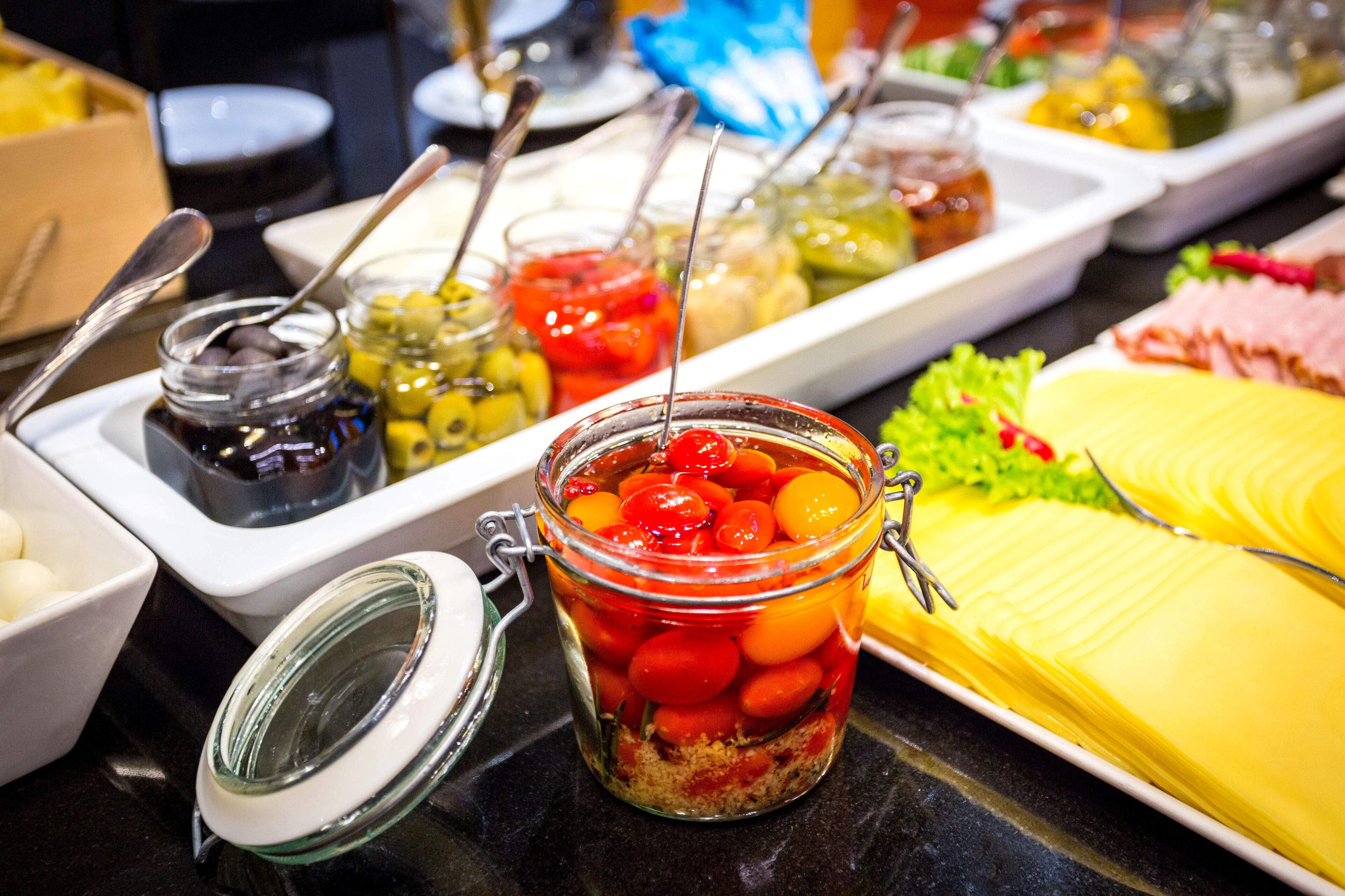 A buffet with various food items and condiments.