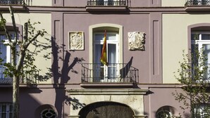Un bâtiment doté d’une entrée centrale, de nombreux balcons et d’éléments décoratifs en pierre.