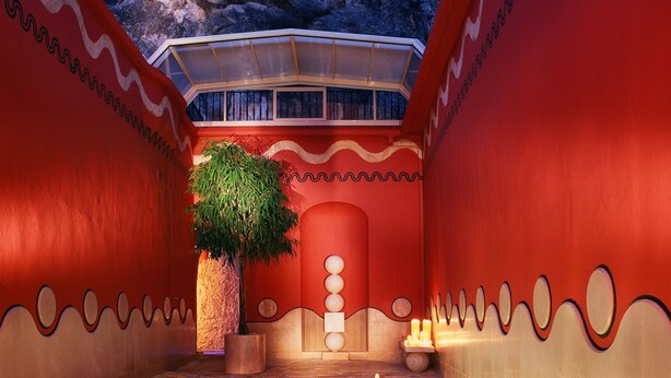 Un espace de bien-être comprenant une piscine, une table de massage et une petite plante.