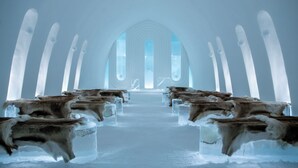An arctic interior with ice benches and a central aisle.