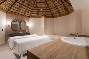 A hotel room with a large bathtub, two beds with white linens, a wooden ceiling, and a large mirror above the vanity. - Tropical Deluxe Princess - All Inclusive (Punta Cana)