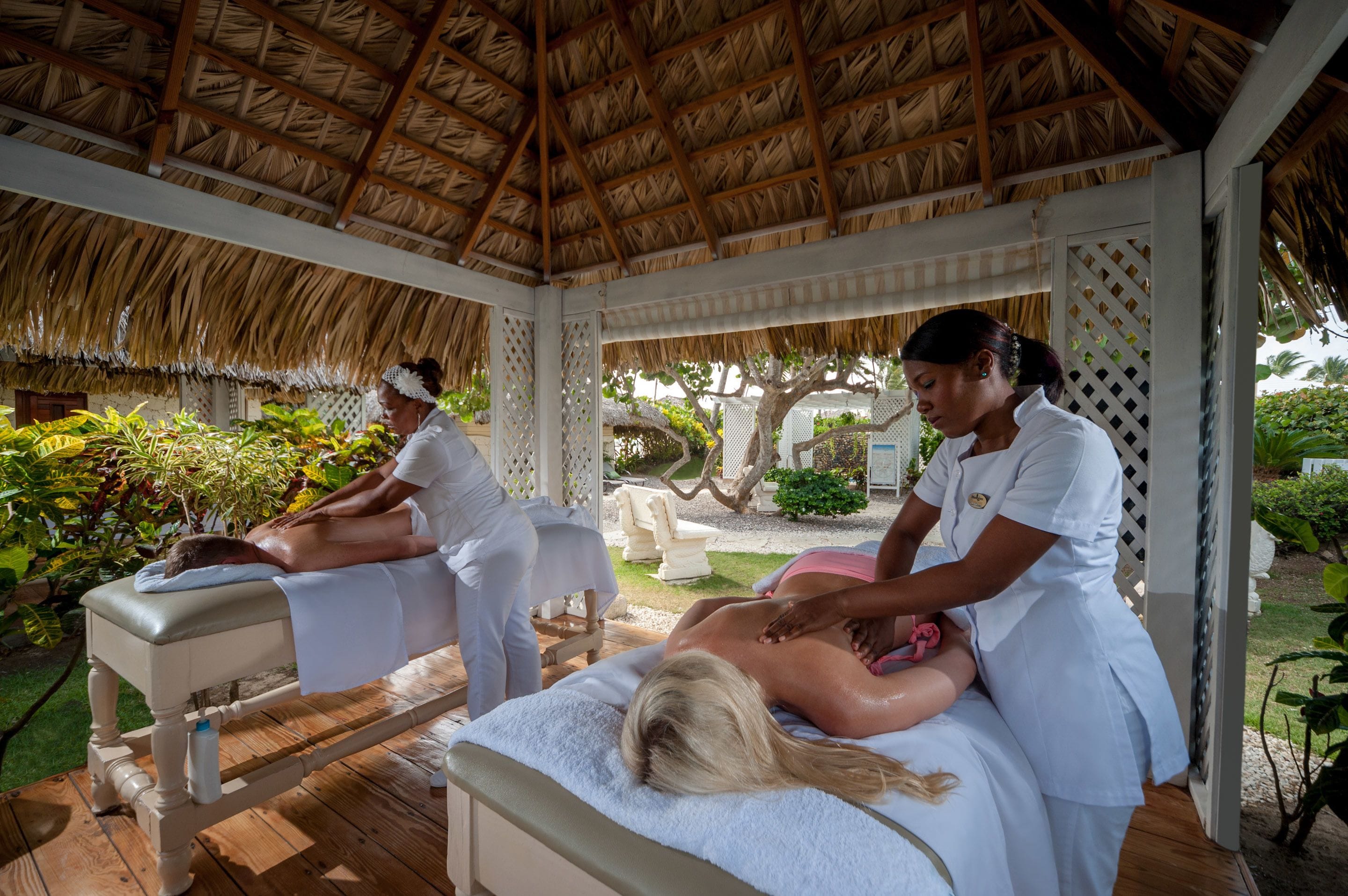 A massage parlor with wooden floors and a thatched roof.