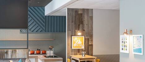 A modern interior with a kitchen, dining area, and seating.