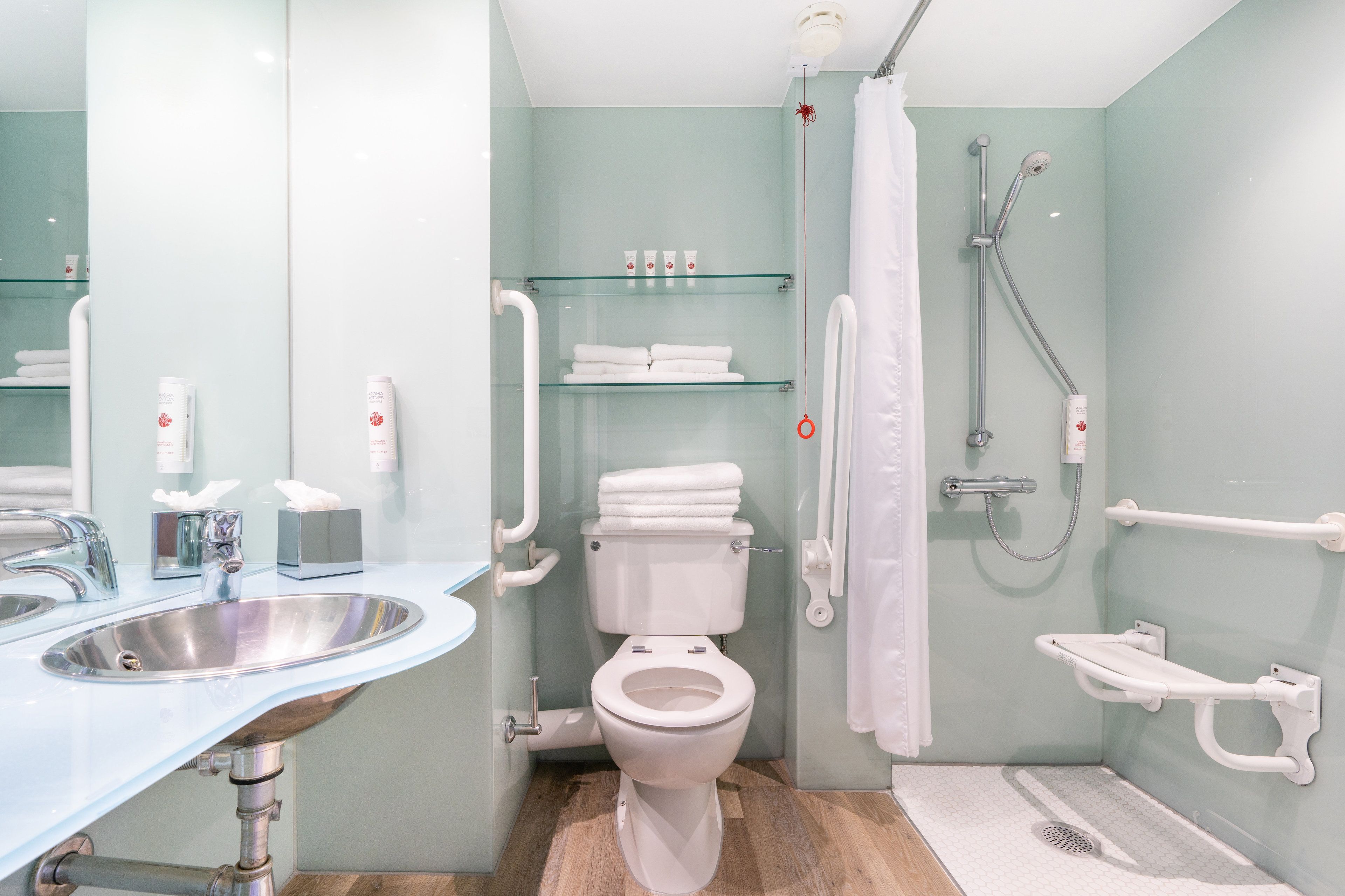 A modern bathroom with a sink, toilet, and shower.