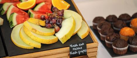 A fruit platter with watermelon, oranges, grapes, and melon slices.