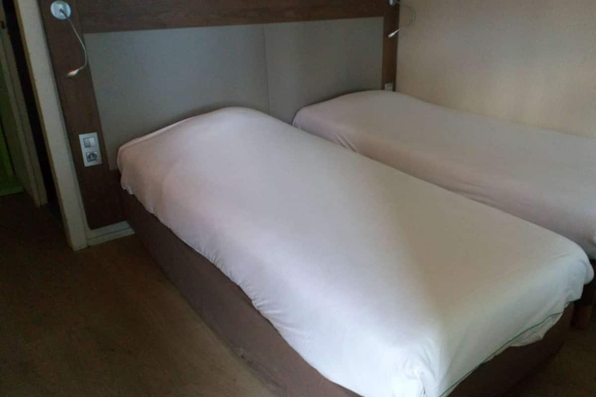 Premium bedding, desk, laptop workspace, blackout drapes