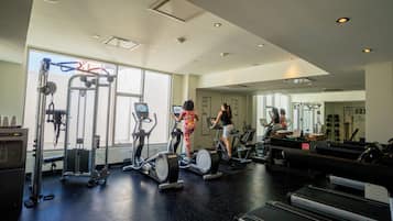 A gym with treadmills, elliptical machines, and weight equipment.