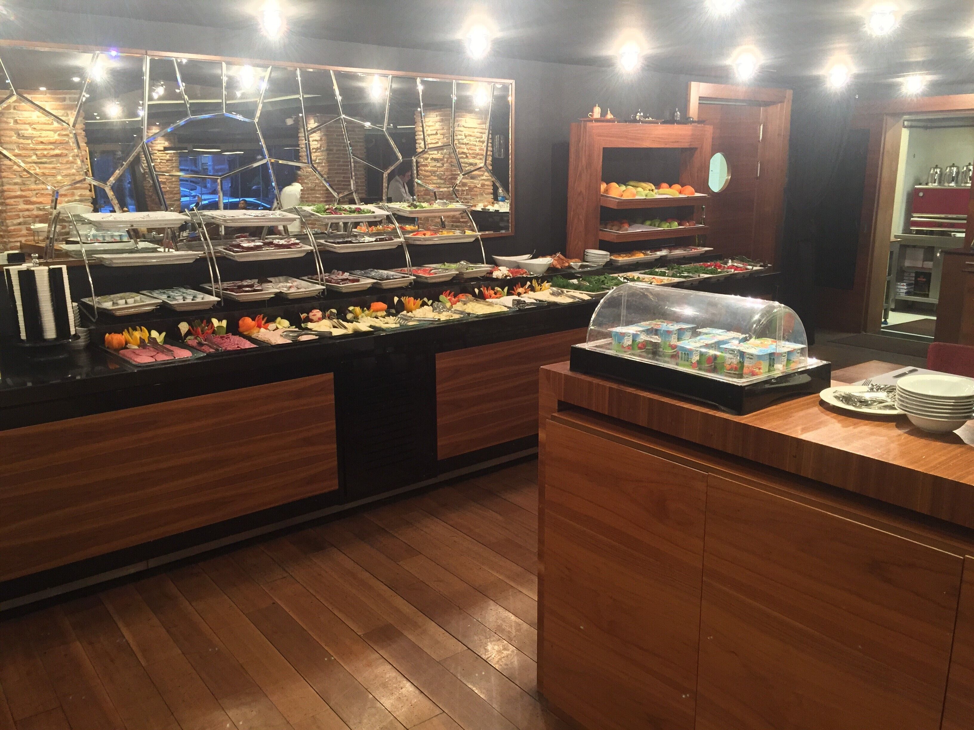 A buffet with various food items and a coffee station.