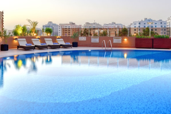 Outdoor pool, open 6 AM to 10 PM, pool umbrellas, pool loungers