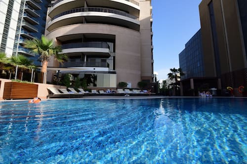 Outdoor pool, open 6 AM to 10 PM, pool umbrellas, sun loungers
