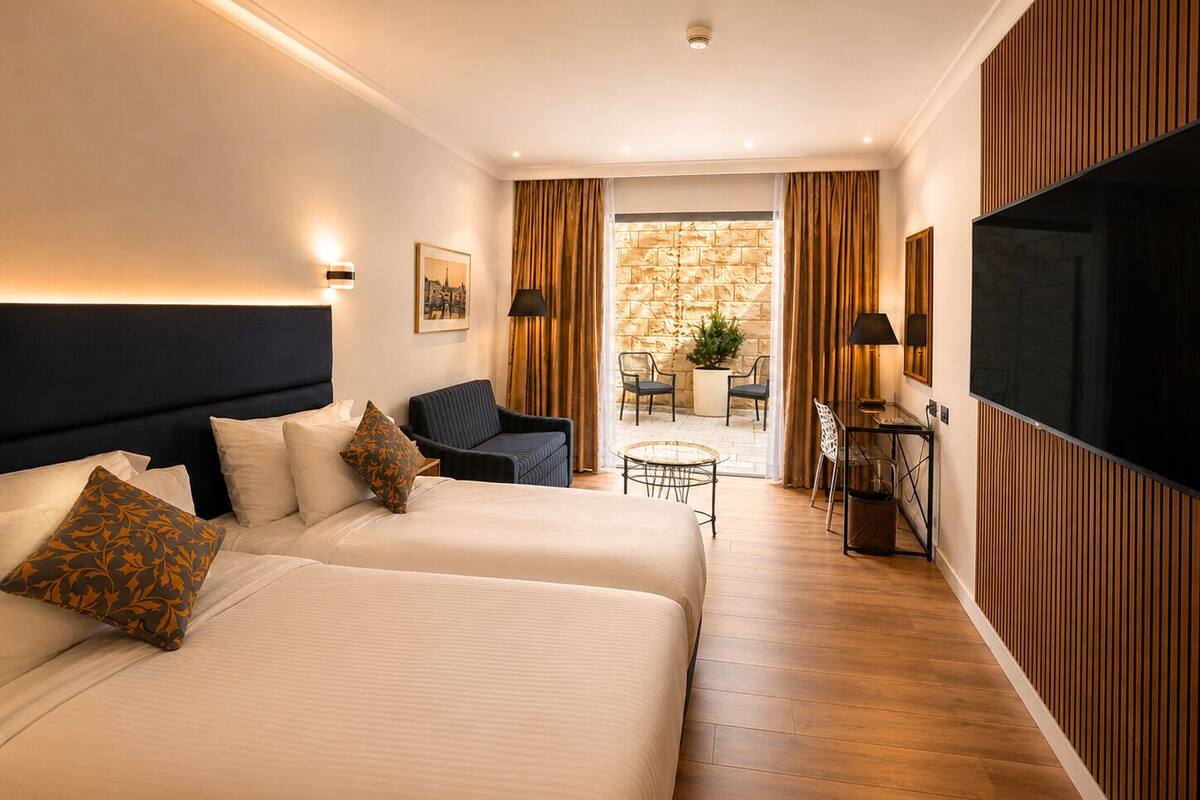 Garden Room | Minibar, in-room safe, iron/ironing board (on request), WiFi (free)