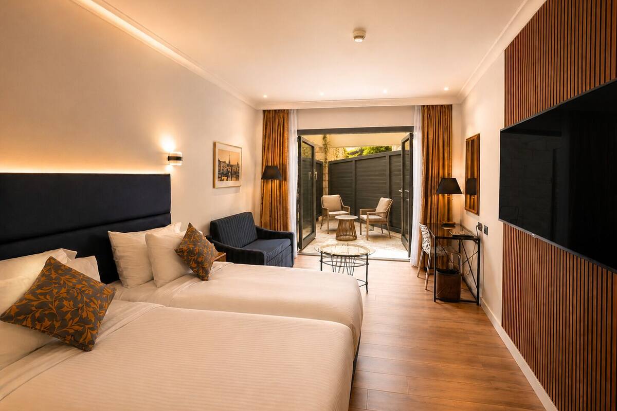 Patio Room | Minibar, in-room safe, iron/ironing board (on request), WiFi (free)