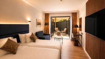 Patio Room | Minibar, in-room safe, iron/ironing board (on request), free WiFi