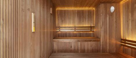 A sauna with wooden walls and benches, a bench in the center, and a small heater on the right.