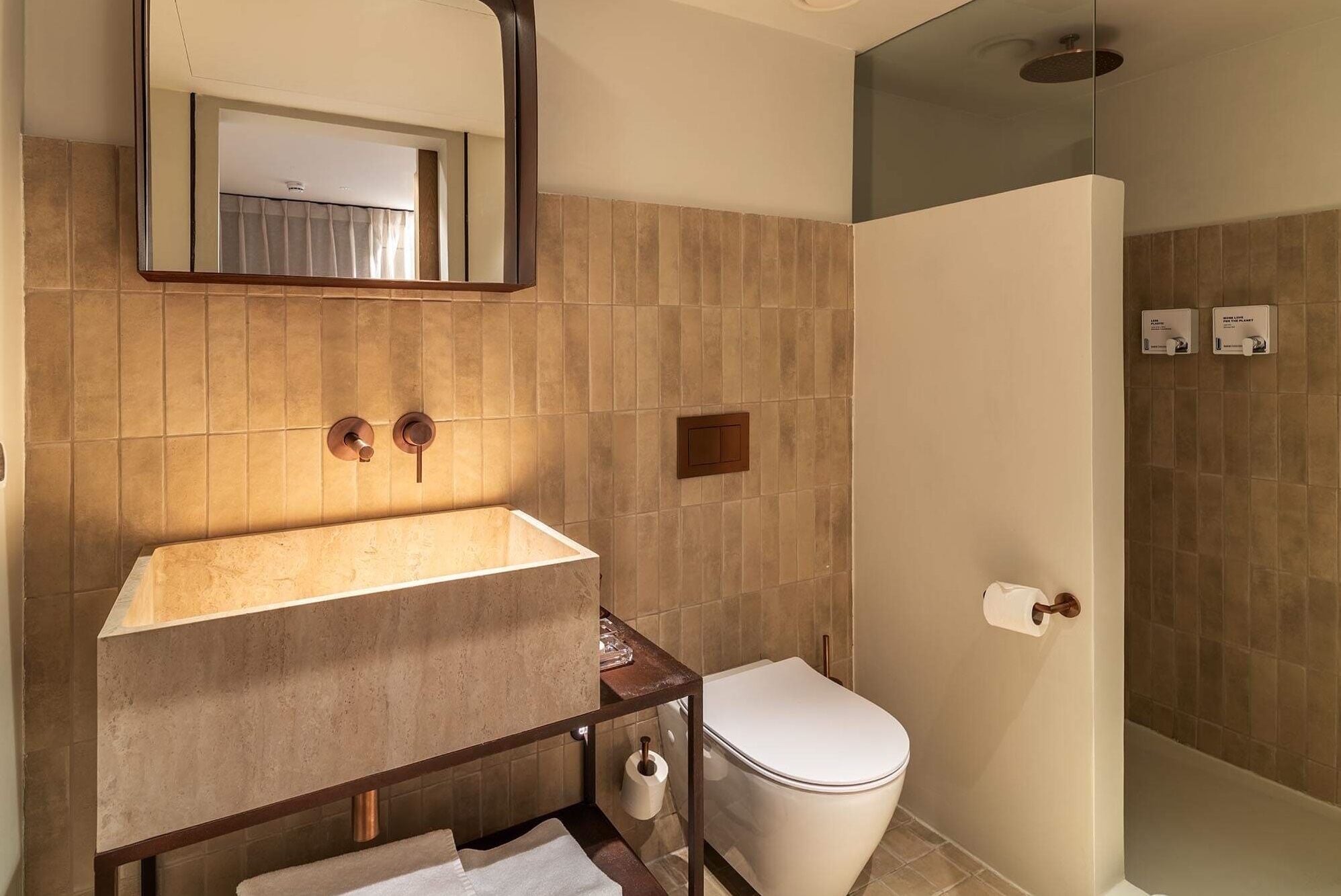 A bathroom with a sink, toilet, and shower.