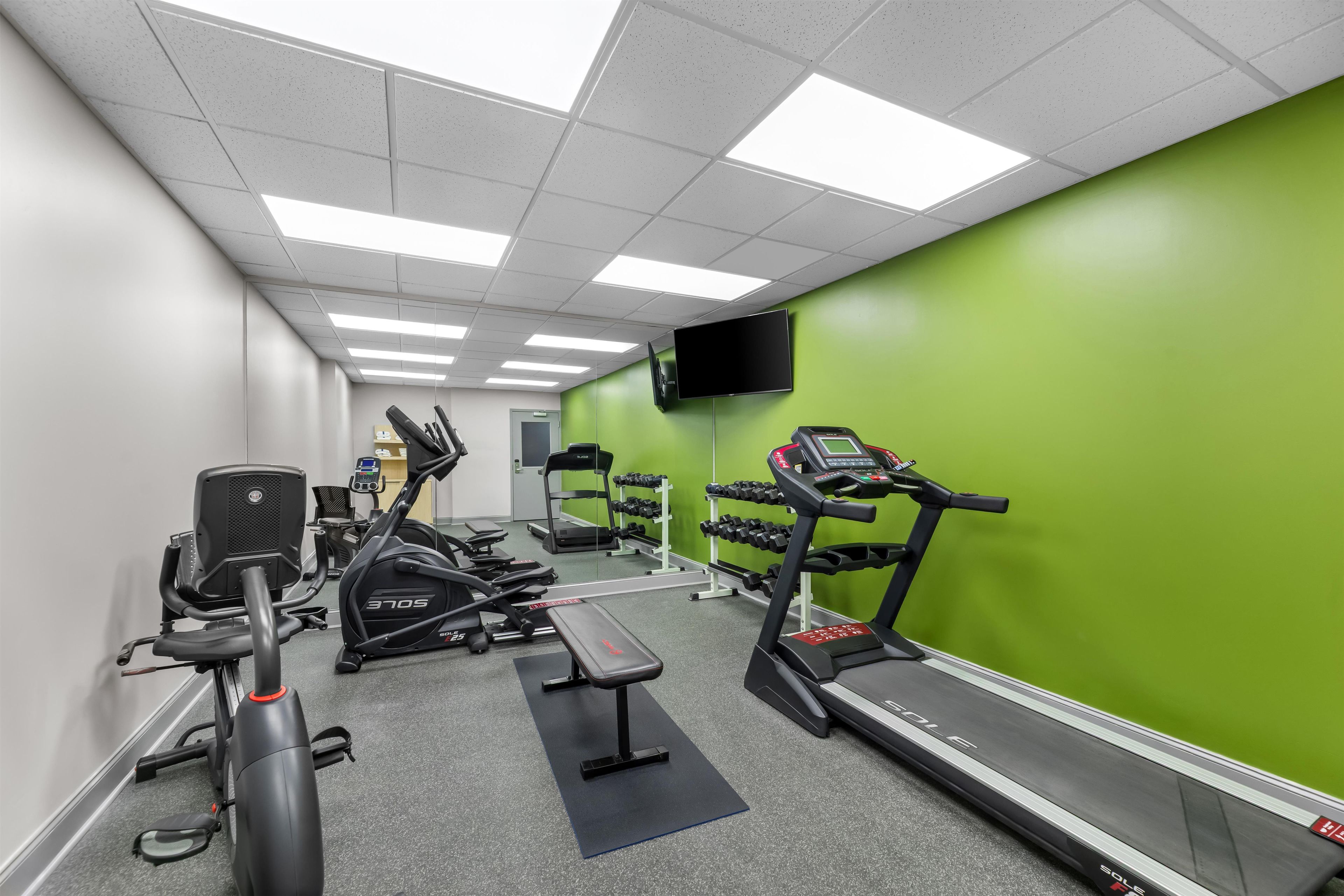 A gym with treadmills, stationary bikes, and weight machines.