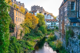 A narrow waterway flanked by historic stone buildings with traditional architecture, including timber framing and steeply pitched roofs.