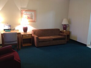 Basic Suite, 1 King Bed with Sofa bed | Living area | TV - America's Best Inns & Suites (Emporia)