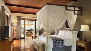 A spacious bedroom with a large bed, a wooden ceiling, and a view of the outdoors. - Alaya Dedaun Kuta (Legian)