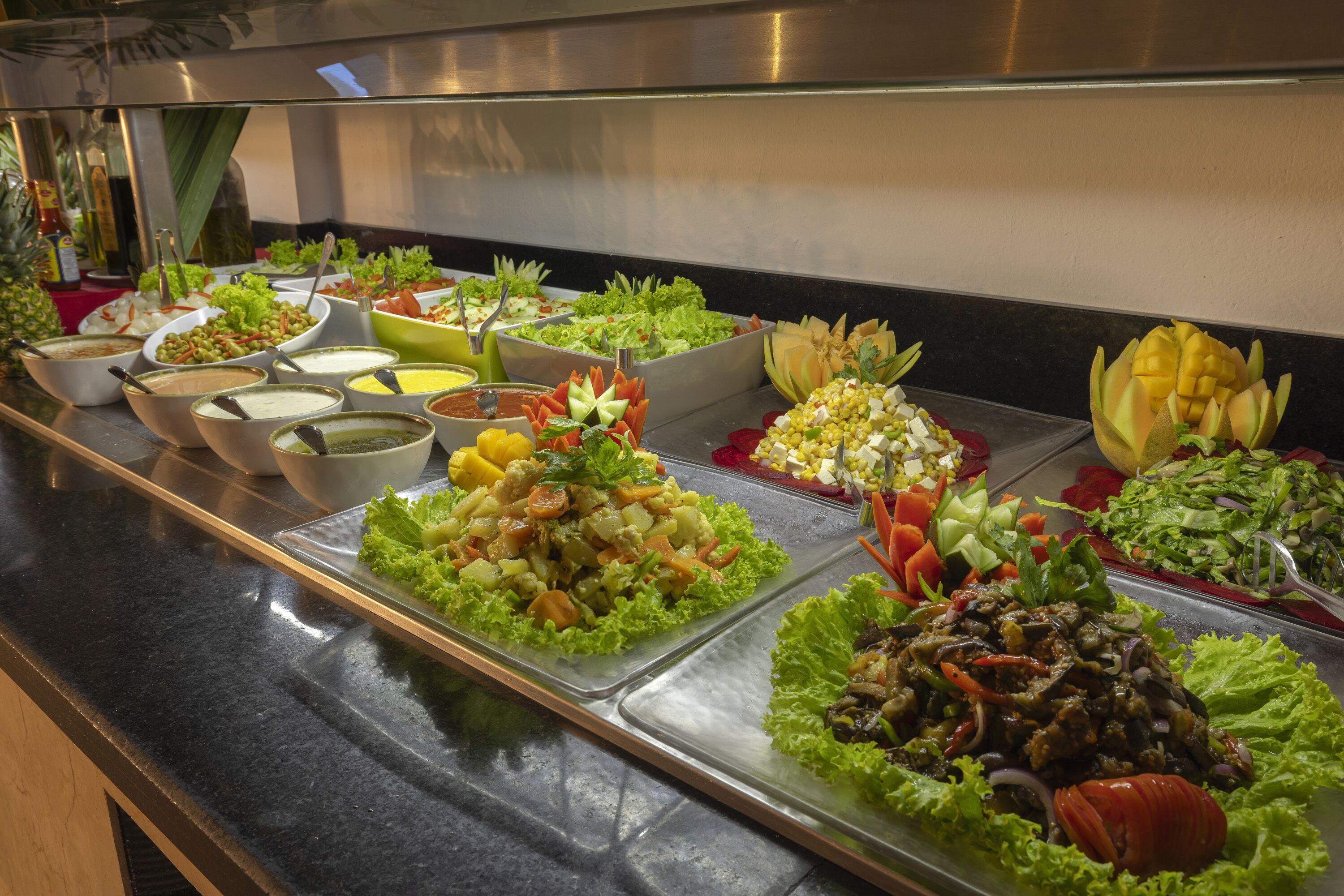 A buffet with various food items and condiments.