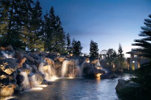 A waterfall in a natural setting with rocks and trees. - Four Seasons Hotel Los Angeles at Westlake Village (Thousand Oaks)