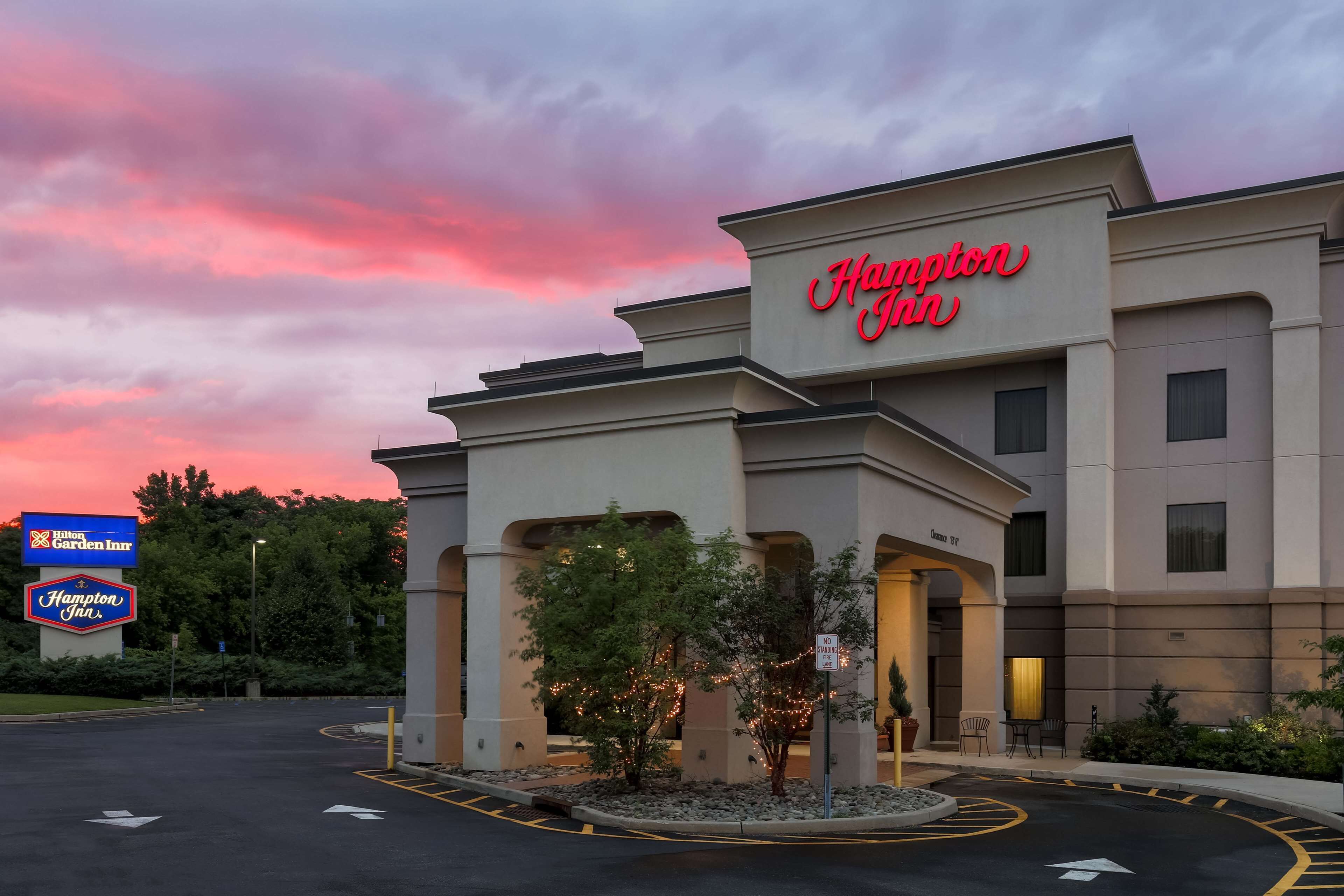A Hampton Inn hotel with a clear sky and sunset.