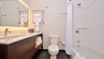 A modern bathroom with a toilet, sink, and shower area.