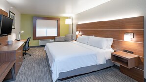 A hotel room with a large bed, a desk with a computer, a chair, a TV, and a window with blinds. - Holiday Inn Express Hotel & Suites ELKINS by IHG (Elkins)