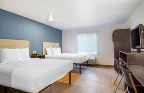 A hotel room with two beds, a TV, and a desk with chairs. - Extended Stay America Select Suites - Charleston - Ashley Phosphate Rd. (North Charleston)