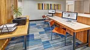 A modern office space with desks, computers, and a plant. - Holiday Inn Express Hotel & Suites Cookeville by IHG (Cookeville)