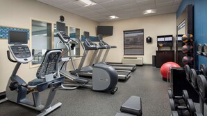 A gym with treadmills, an elliptical, a stationary bike, and various weights. - Hampton Inn Knoxville East (Knoxville)
