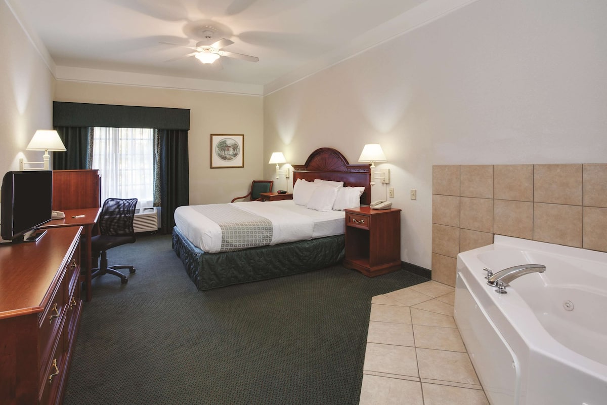 Premium bedding, desk, laptop workspace, blackout drapes