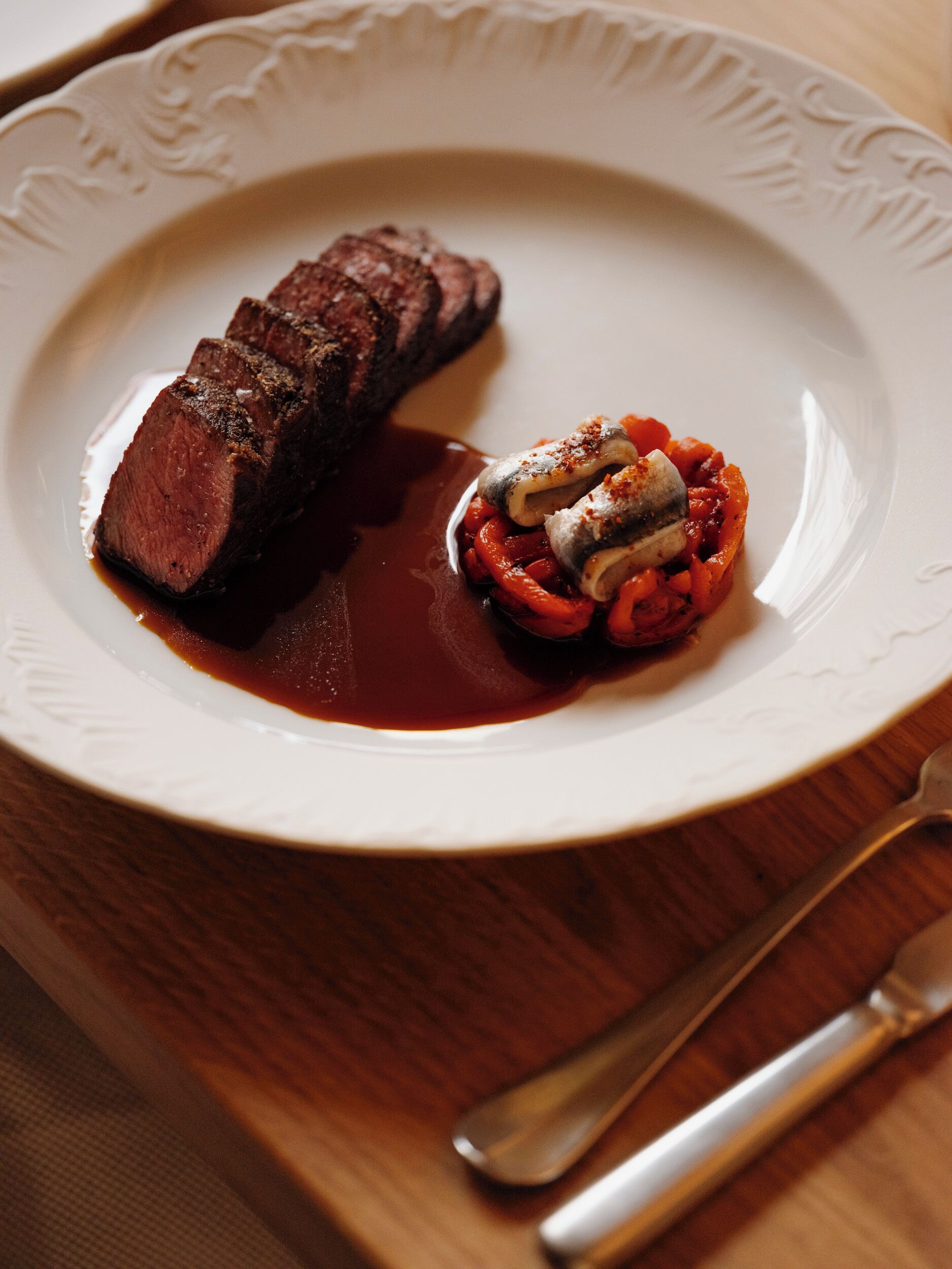 A plate with a steak and a side of vegetables.
