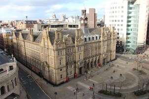 A historic building with a symmetrical facade, large windows, and a central clock tower.