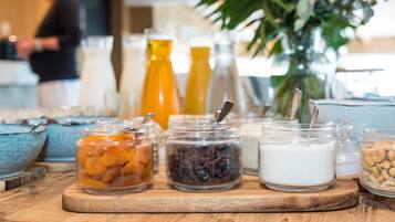 A breakfast buffet with various food items and beverages.