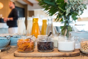 A breakfast buffet with various food items and beverages.