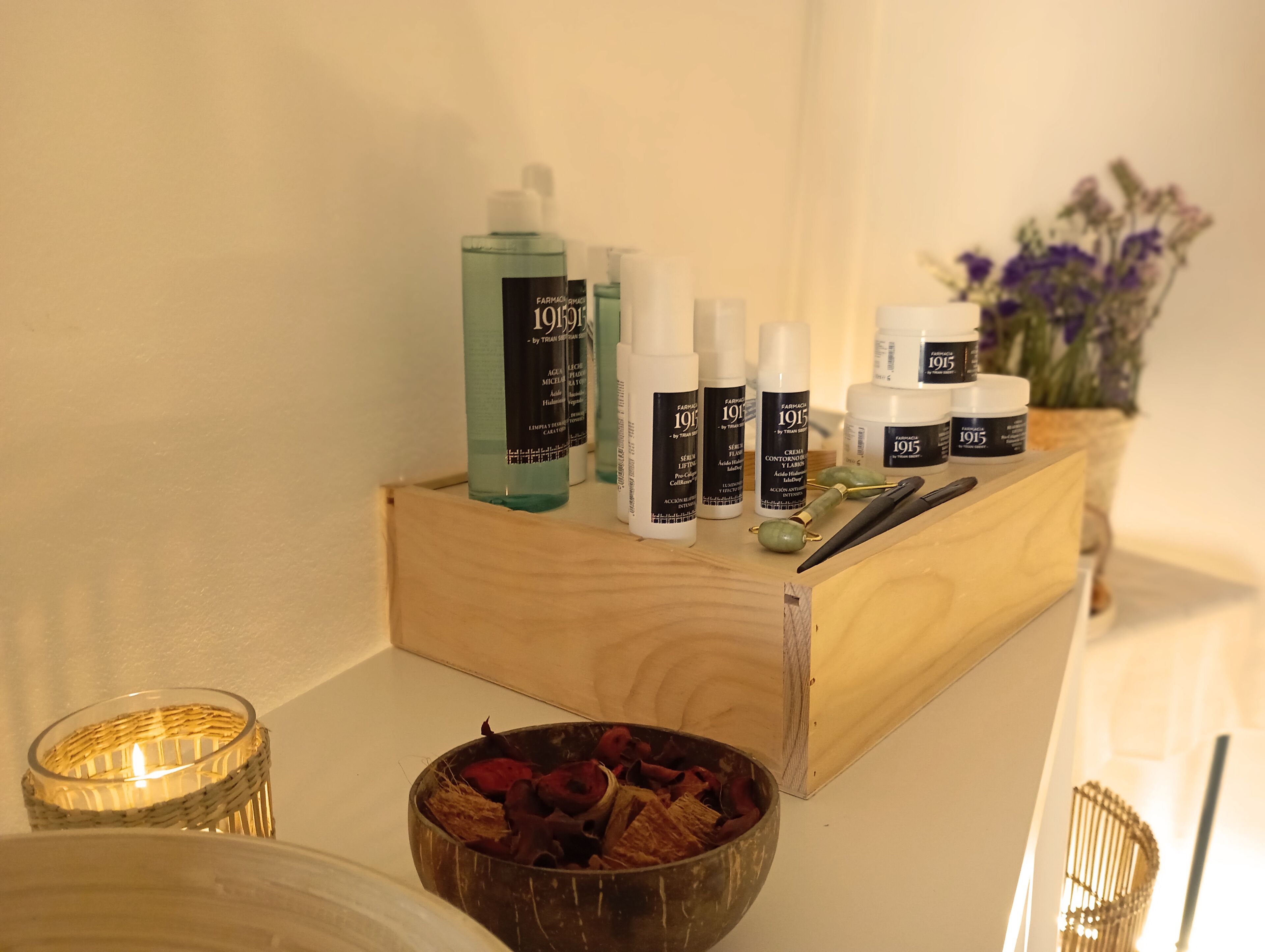 A wooden box containing various skincare products on a table.