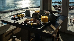 A breakfast tray on a balcony with a view of the ocean. - ICON Valparaiso - Adults Only (Manacor)