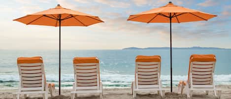 On the beach, sun-loungers, beach umbrellas, beach towels