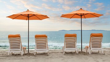 On the beach, sun loungers, beach umbrellas, beach towels