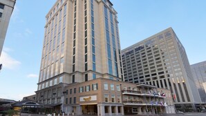 A hotel with a classic architectural style, featuring a prominent corner location, multiple floors, and a large entrance with a sign.