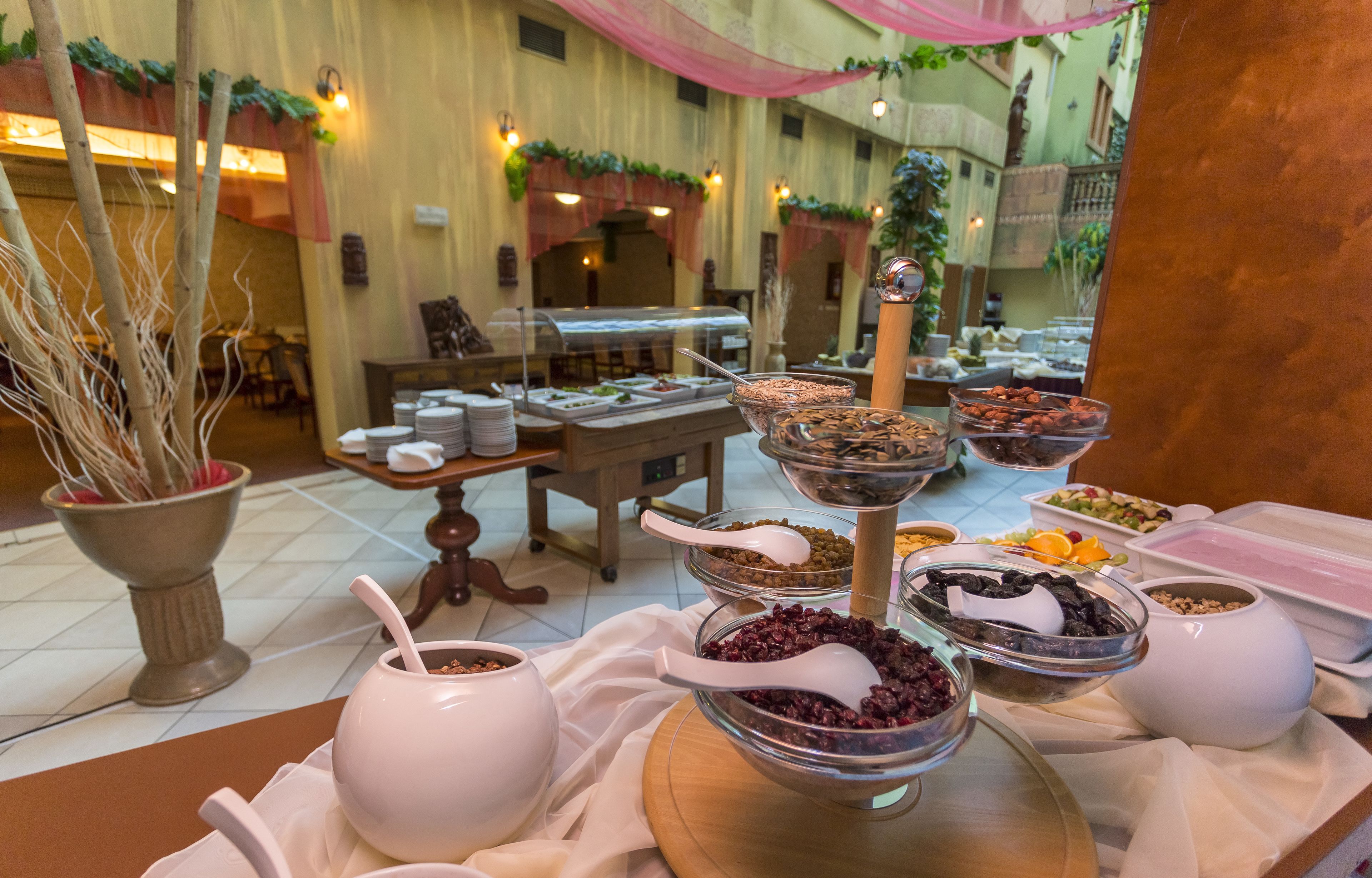 A buffet setup with various food items and serving utensils.